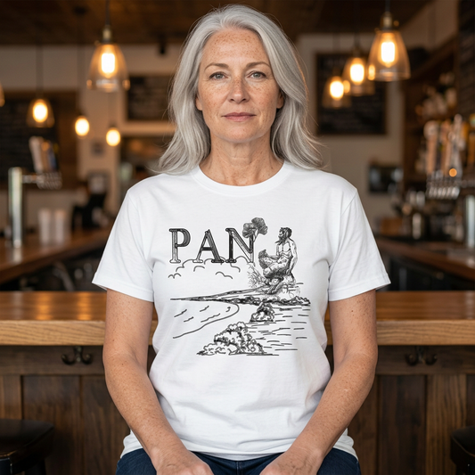 White Pan graphic tee on a silver-haired woman model seated in a warm bar setting